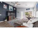 Comfortable living room featuring a large sectional sofa, ceiling fan, and stylish decor at 1130 W Kingbird Dr, Chandler, AZ 85286