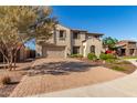 Attractive two-story home with a brick driveway, well-kept lawn, and a two car garage at 11844 W Nadine Way, Peoria, AZ 85383