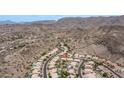 Aerial view of a desert neighborhood with well-maintained homes, tile roofs, and mountain backdrop at 14033 S 31St St, Phoenix, AZ 85048