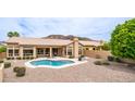 Backyard oasis features a freeform pool, desert landscaping, and an outdoor seating area with mountain views at 14033 S 31St St, Phoenix, AZ 85048