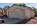 Spacious attached garage with a large driveway, perfect for multiple vehicles at 150 N Nielson St, Gilbert, AZ 85234