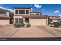 Charming two-story townhome with a two-car garage and appealing desert landscaping at 15550 N Frank Lloyd Wright Blvd # 1101, Scottsdale, AZ 85260