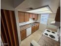Efficient kitchen layout with ample storage, basic appliances, and practical countertop space at 16602 N 25Th St # 217, Phoenix, AZ 85032
