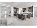 Open kitchen boasts a spacious island with bar seating and stainless steel appliances at 18883 E Celtic Manor Dr, Queen Creek, AZ 85142