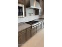 Gourmet kitchen featuring stainless steel appliances, granite countertops, and ample cabinet space at 18883 E Celtic Manor Dr, Queen Creek, AZ 85142