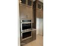 Modern kitchen design showcasing stainless steel double ovens, granite countertops, and custom cabinets at 18883 E Celtic Manor Dr, Queen Creek, AZ 85142