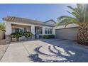 Attractive single-story home with a desert landscape, palm tree, and a spacious two-car garage at 19323 E Canary Way, Queen Creek, AZ 85142