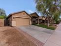 Charming single-story home featuring a two-car garage, neutral stucco, and well-kept landscaping at 21533 N Greenway Rd, Maricopa, AZ 85138
