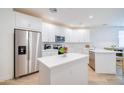 Bright kitchen with white cabinets, stainless steel appliances, quartz countertops, and island at 2511 W Queen Creek Rd # 374, Chandler, AZ 85248