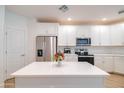 Bright kitchen with white cabinets, stainless steel appliances, quartz countertops, and island at 2511 W Queen Creek Rd # 374, Chandler, AZ 85248