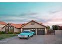 Charming single-story home with a blue truck, lush plants and an attached two-car garage at 2917 E Northridge St, Mesa, AZ 85213