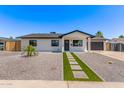 Charming single-story home with gravel landscaping, a modern walkway, and fresh curb appeal at 2926 E Corrine Dr, Phoenix, AZ 85032