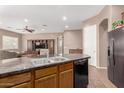 Modern kitchen features an island with a sink, granite countertops, and stainless steel appliances at 2945 E Clifton Ave, Gilbert, AZ 85295