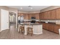 Open kitchen features granite countertops, an island with seating, and stainless steel appliances at 2945 E Clifton Ave, Gilbert, AZ 85295