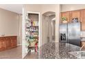 Walk-in pantry provides ample storage space and stainless steel refrigerator in kitchen at 2945 E Clifton Ave, Gilbert, AZ 85295
