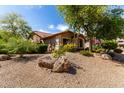 Desert landscaping with rocks and yellow flowers at 29506 N 21St Ave, Phoenix, AZ 85085