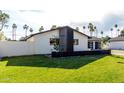 Modern single-story home with manicured lawn and decorative privacy wall, offering curb appeal at 3502 N Rose Circle Dr, Scottsdale, AZ 85251