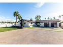Contemporary home featuring a well-manicured lawn, spacious driveway, and modern architectural details at 3502 N Rose Circle Dr, Scottsdale, AZ 85251