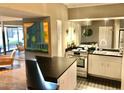 Well-lit kitchen with stainless steel appliances, mirrored backsplash and modern decor at 351 E Thomas Rd # D106, Phoenix, AZ 85012