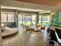 Cozy living room with stylish furniture, natural light, and access to a private outdoor area at 351 E Thomas Rd # D106, Phoenix, AZ 85012