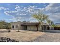 Exterior view of a tan stucco home in a desert landscape with mountain views at 36721 N 17Th Ave, Phoenix, AZ 85086