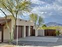 A three car garage, wooden fence, desert landscaping and mountain views at 36721 N 17Th Ave, Phoenix, AZ 85086