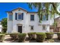 Charming two-story home featuring a stucco exterior, decorative shutters, and a tile roof at 4243 E Jasper Dr, Gilbert, AZ 85296