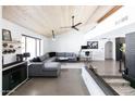 Bright living room featuring concrete floors, a wooden ceiling, modern furniture, and office space at 4317 E Ludlow Dr, Phoenix, AZ 85032