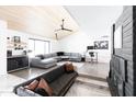 Bright living room with concrete floors, a wooden ceiling, modern furniture, and fireplace at 4317 E Ludlow Dr, Phoenix, AZ 85032