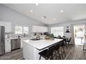 Bright kitchen features an island with bar seating, stainless steel appliances, and tile backsplash at 4609 E Monte Cristo Ave, Phoenix, AZ 85032