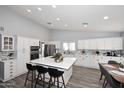 Modern kitchen features an island with bar seating, recessed lighting, and stainless steel appliances at 4609 E Monte Cristo Ave, Phoenix, AZ 85032