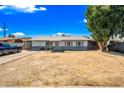 Charming single-story home with a well-maintained yard and a cozy, inviting front porch at 4828 N 71St Ave, Phoenix, AZ 85033