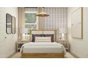 Stylish bedroom with designer wallpaper, a wood frame bed, and ample natural light at 4987 S 233Rd Dr, Buckeye, AZ 85326