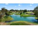 Picturesque aerial view of a scenic golf course with beautiful ponds and well-maintained landscaping at 633 Leisure World --, Mesa, AZ 85206