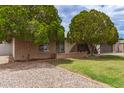 Charming single-story home with mature landscaping and a well-kept yard, offering great curb appeal at 6869 E Flossmoor Ave, Mesa, AZ 85208