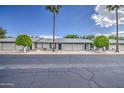 Street view of well-maintained homes featuring lush landscaping, garages, and inviting entrances at 7950 E Keats Ave # 175, Mesa, AZ 85209