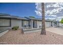 Single-story home featuring a charming front porch, desert landscaping, and an attached garage at 7950 E Keats Ave # 175, Mesa, AZ 85209