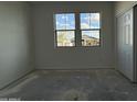 Sunlit bedroom with double windows offering neighborhood views and a closet at 9536 W Parkway Dr, Tolleson, AZ 85353