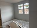 Unfinished bedroom featuring drywall and natural light from two windows at 9536 W Parkway Dr, Tolleson, AZ 85353