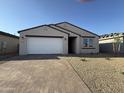 Attractive single-story home with a brick-paved driveway and low-maintenance desert landscaping at 9536 W Parkway Dr, Tolleson, AZ 85353