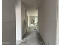 Unfinished hallway showcasing the drywall work and the view of a backyard door at 9536 W Parkway Dr, Tolleson, AZ 85353