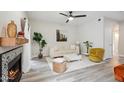 Comfortable living room with stylish furniture, accent plants, and a fireplace adding a cozy ambiance at 9600 N 96 Th St # 130, Scottsdale, AZ 85258