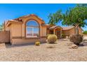 Single-story home with desert landscaping, complemented by a neutral color palette at 975 E Lincolnwood Cir, Casa Grande, AZ 85194