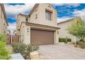 Two-story home with a tan exterior, brown garage door, desert landscaping, and a tile roof at 10050 E Texas Ave, Mesa, AZ 85212