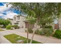 Street view of a two-story home with a desert landscaped yard, neutral color, and tile roofing at 10050 E Texas Ave, Mesa, AZ 85212