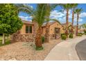 A charming front exterior featuring desert landscaping, stucco and stone accent walls at 1022 W Calypso Ct, Gilbert, AZ 85233