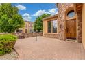 Charming front porch with stone accents and brick-paved patio at 1022 W Calypso Ct, Gilbert, AZ 85233