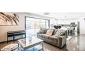 This open-concept living room flows into the kitchen with modern decor and lots of natural light at 11215 N 37Th Ave, Phoenix, AZ 85029