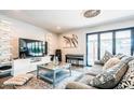Bright living room with a large TV, modern shelving, comfortable seating and a sliding glass door at 11215 N 37Th Ave, Phoenix, AZ 85029