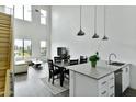Bright open-concept kitchen and living space featuring high ceilings, large windows, and a crisp, white color scheme at 1130 N 2Nd St # 401, Phoenix, AZ 85004